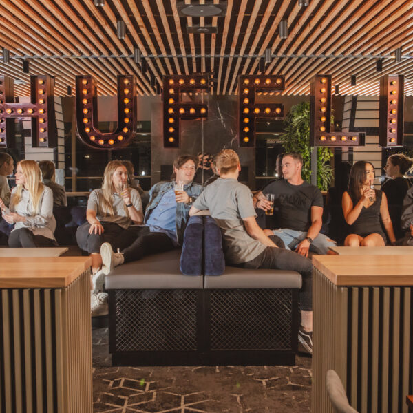 People sitting in front of Shufflin sign